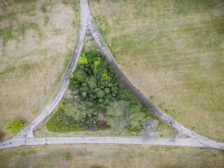 Park with a tree in the middle of a triangle