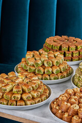 A picture of several dishes of Arabic and Turkish sweets with pistachios, Ramadan sweets.