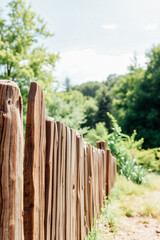 Fototapeta premium Rustic Wooden Fence in Lush Green Landscape