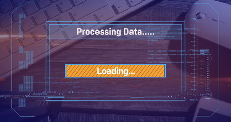 Image of loading over digital screen, mouse and keyboard on desk