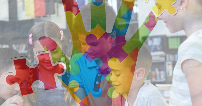 Jigsaw puzzle and hand icon against diverse group of students using digital tablet at school