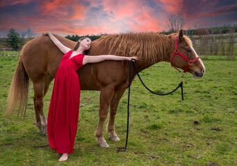 A young woman in a red dress with a horse
