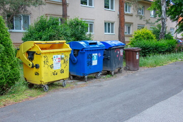 Nitra, Slovakia - 05.21.2025: Garbage bins on street. Caring for environment, sorting garbage into...