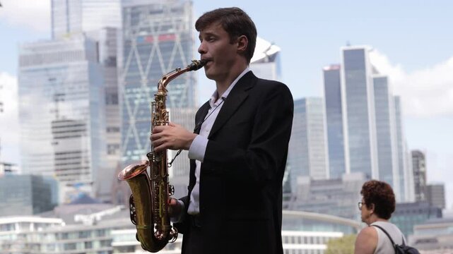 Talented saxophonist performs against the backdrop of a busi