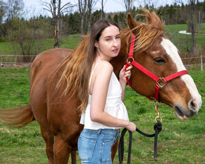 A young woman wit her horse