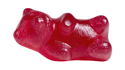 Closeup view of a single shiny red gummy bear candy in the shape of a bear lying on a transparent background, perfect for food and beverage, confectionery, or childhood themed projects
