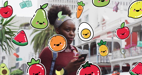 Image of food and toys icons over african american woman using smartphone