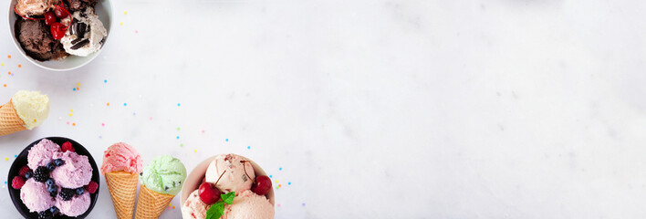 Summer ice cream corner border. Bowls and cones of colorful assorted flavors. Top view on a white marble banner background. Copy space.