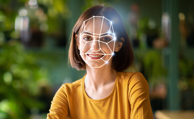 In a modern setting, a woman is engaged in a facial recognition check, demonstrating the use of...