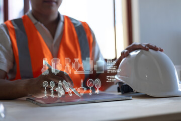 Industrial engineer siting check gas generator in power plant and controlling electricity production on his tablet.