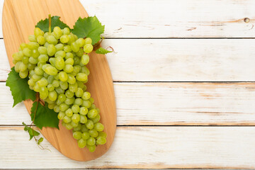 Fresh green grape on wooden background, top view