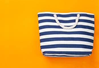 Blue beach bag on color background, top view