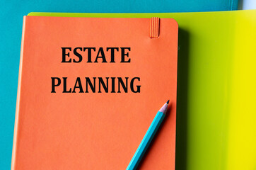 ESTATE PLANNING - words on an orange notepad on a background of multi-colored folders