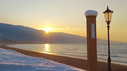 Snowy Beach Sunset Landscape with Lamppost and Mountains