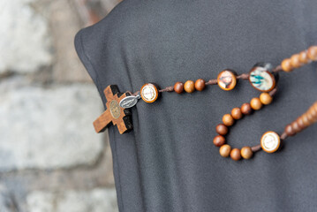 Detail of a crucifix of a Catholic faithful. Palm Sunday Mass.
