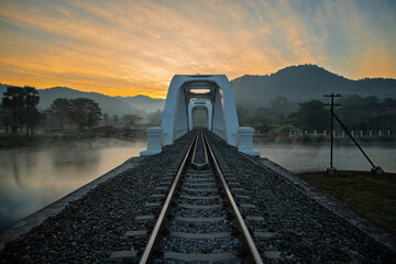 The white bridge Tha Chom Phu bridge over the railway tracks at northern Thailand.