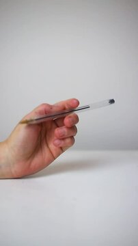 Anxious person fingering pen