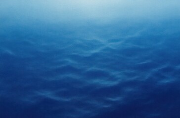 Fototapeta premium Close-up view of calm water surface with gentle ripples and gradient blue tones conveying tranquility and depth