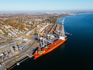 Naklejka premium Ship is in the dock, container port. Montreal, Quebec, Canada.