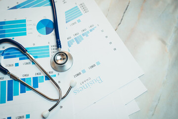 Health care concept. Stethoscope and Business Charts on Table with Data Visualization and Analytics for Healthcare Professionals