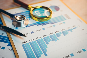 Health care concept. Medical Analysis with Stethoscope, Magnifying Glass, and Data Charts on a Desk for Research and Interpretation