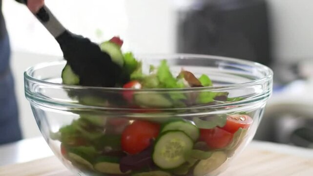 Tossing Fresh Mixed Salad in Bowl Slow Motion - Healthy Food Preparation Stock Video Clip