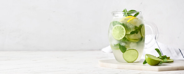 Jug of fresh mojito on table