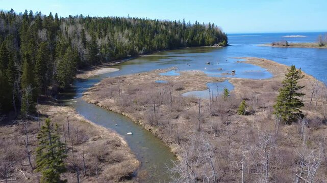 Drone video of the delta at the mouth of the Mitis salmon river where it flows into the St. Lawrence River estuary at Grand‑M&eacute;tis, Gasp&eacute;sie, Quebec, Canada.