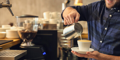 Barista preparing fresh aromatic coffee in cafe