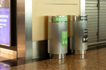 Metal airport litter garbage cans, with differentiated waste and recycling bins.