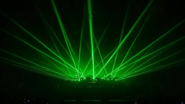 Green laser beams in a dark venue.