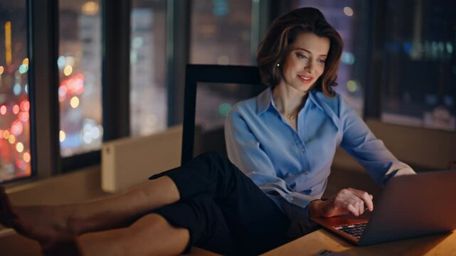 Businesswoman putting feet desk making coffee break at night workplace closeup