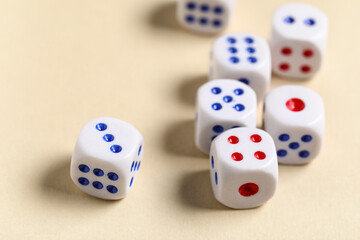 White game dices on beige background, closeup