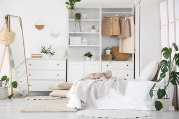 Interior of teenager's room with bed, mirror and closet
