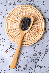 Black sesame seed in wooden spoon, Food ingredient, Top view