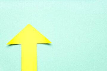 Yellow paper arrow on blue background
