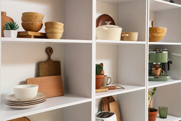 Shelf unit with kitchen utensils and plants