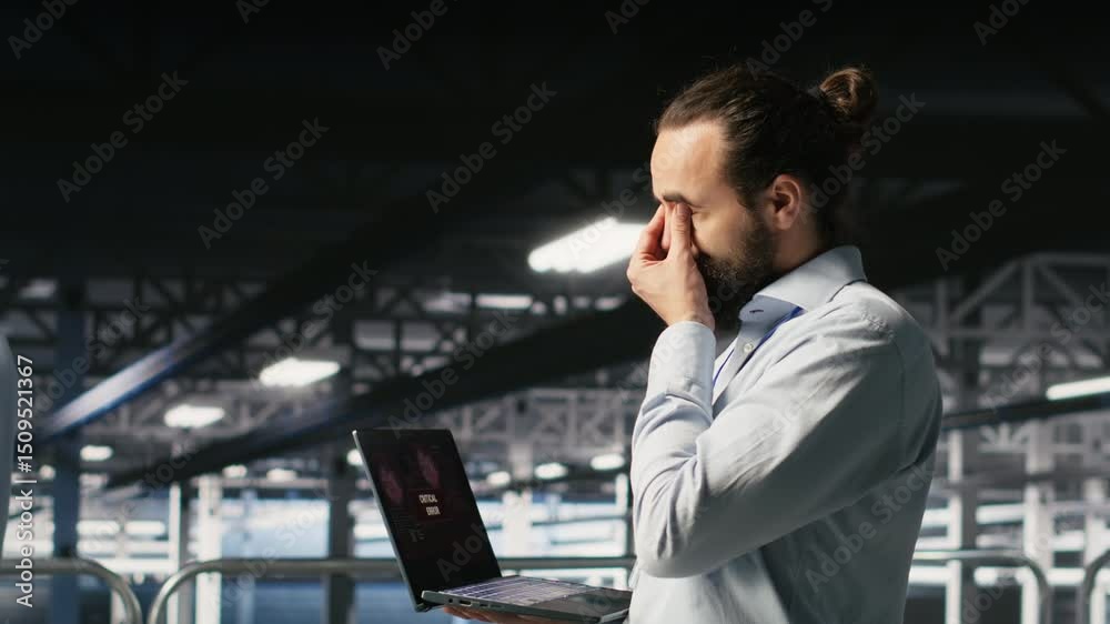 Poster data center developer frustrated by critical error affecting laptop. irate server farm worker reacti