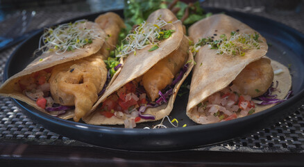 Delicious Mexican Fish Tacos on a Black Plate, Battered and Fried Fish on Corn Tortillas