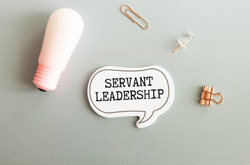 Servant Leadership write on paperwork isolated on Wooden Table