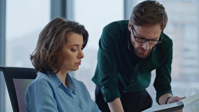 Serious boss asking manager about report data in company workspace closeup.
