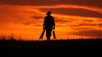 Silhouette person walking sunset field