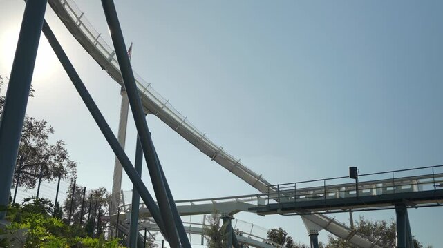 Enjoy an exhilarating day at a marine adventure park as visitors prepare for an exciting waterslide ride under the bright blue sky, surrounded by lush greenery and thrilling attractions.