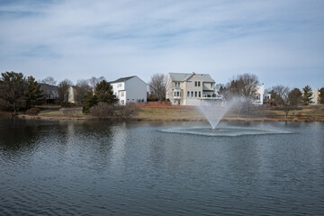 Suburban lake with fountain and homes in Ashburn Virginia