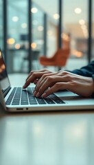 person typing on a laptop on a table