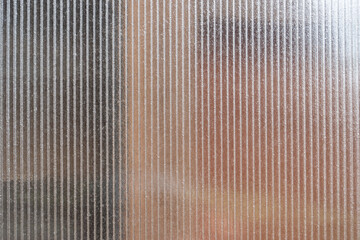 Close-Up of Translucent Ribbed Plastic Panel with Soft Light and Shadow