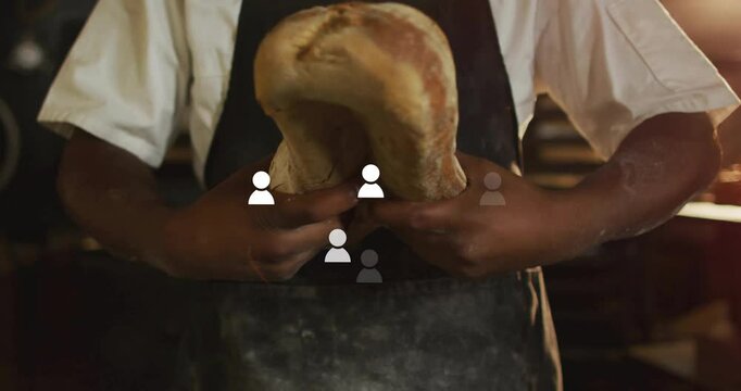 Male baker bending bakery loaf at center crease pulling apart with animated crust showing crumb