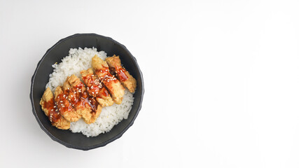 Rice bowl with chicken katsu and topped with sauce and sesame seeds