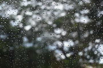 water drop on mirror in rainy day, blur natural background