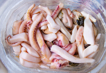 Top view of seafood, ready to eat tentacles and squid, food background